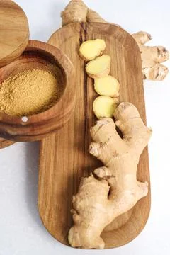 Ginger root and ginger powder in the bowl Stock Photos