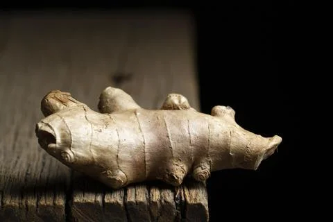 Ginger root and powder on a rustic wood, close-up image Stock Photos