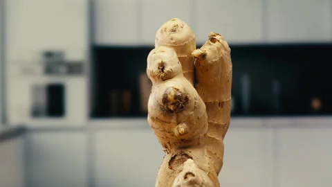 Ginger root and sliced on old plank with nature background. Close-up, food Stock Footage 309622701