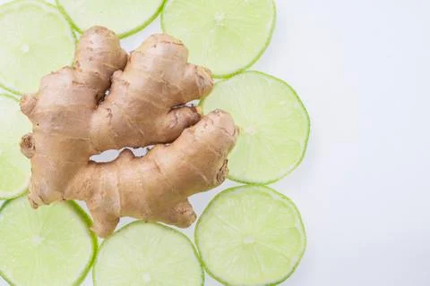 Ginger root and slices of lemon on white background Stock Photos