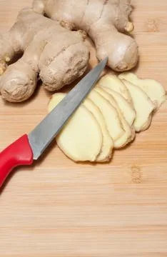 Ginger root on a bamboo chopping block Stock Photos