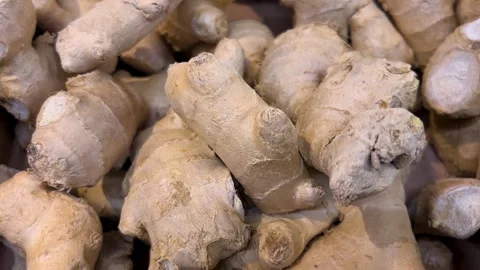 Ginger root in cardboard box displayed on greengrocer's counter Stock Footage 282058247