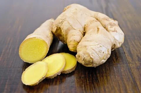 Ginger root cut into the dark board 스톡 사진
