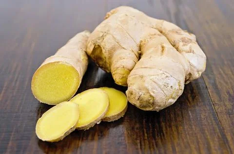 Ginger root cut into the dark board Ginger root cut on a dark wooden board... Stock Photos