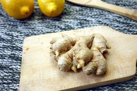 Ginger root on cutting board Stock Photos