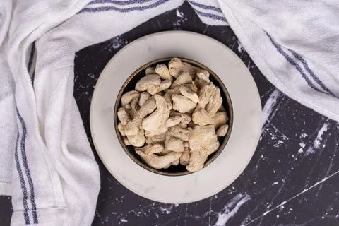 Ginger root on dark background. Ginger root in wooden bowl. Mixture of spices Stock Photos