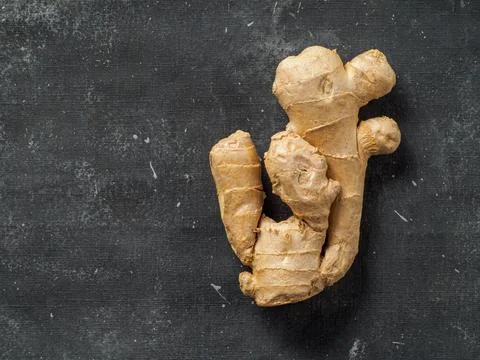 Ginger root on dark background. Stock Photos