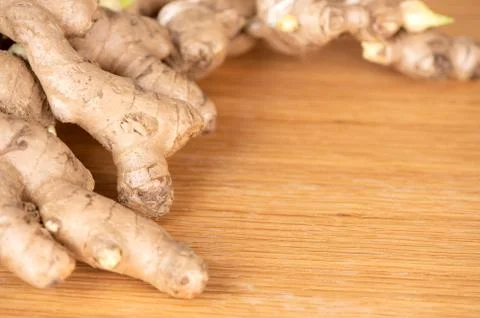 Ginger root, ginger slice and ginger powder on wooden background table, space Stock Photos