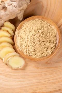 Ginger root, ginger slice and ginger powder on wooden background table, space Stockfoto's