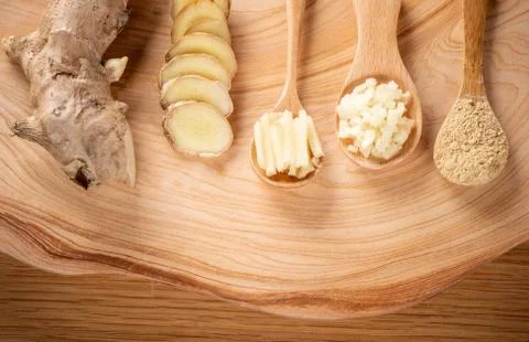 Ginger root, ginger slice and ginger powder on wooden background table, space Stock Photos