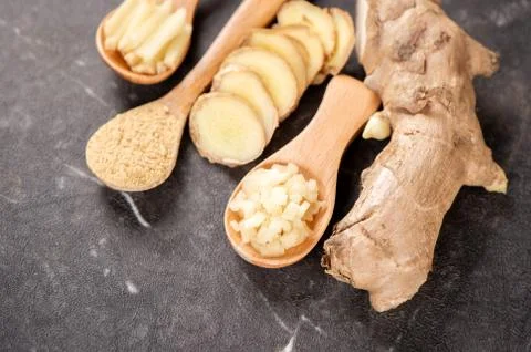 Ginger root, ginger slice and ginger powder on stone background table, space  Stockfoto's