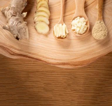 Ginger root, ginger slice and ginger powder on wooden background table, space Stockfoto's