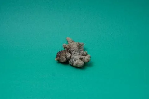 Ginger root isolated on green background Stock Photos