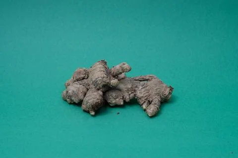 Ginger root isolated on green background Stock Photos