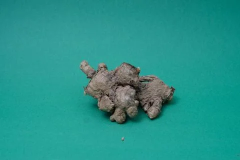 Ginger root isolated on green background Stock Photos