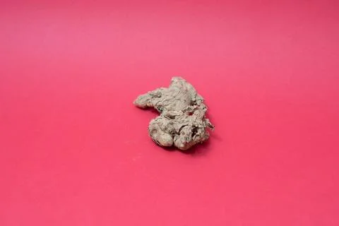 Ginger root isolated on red background Stock Photos