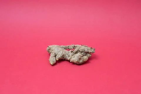 Ginger root isolated on red background Stock Photos
