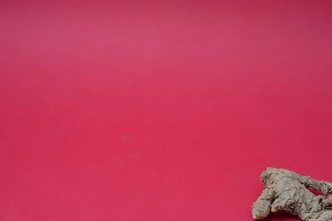 Ginger root isolated on red background Stock Photos