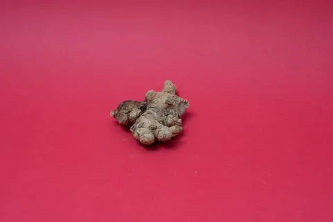 Ginger root isolated on red background Stock Photos