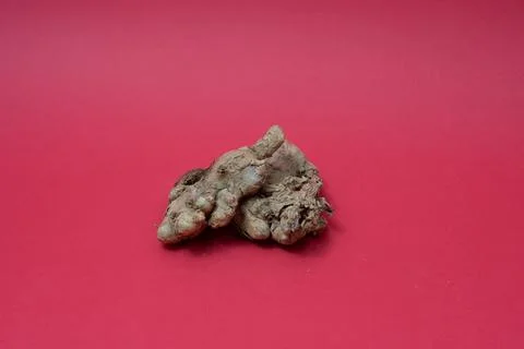 Ginger root isolated on red background Stock Photos