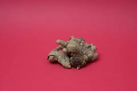 Ginger root isolated on red background Stock Photos