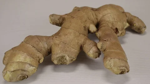 Ginger root lies on a light surface Stock Footage 122512780