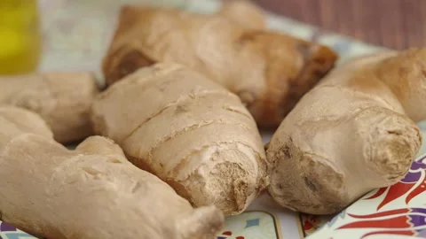 Ginger root preparation at home in a kitchen setting Stock Footage 329902623