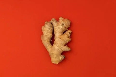 Ginger root on a red background Stock Photos
