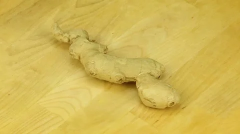 Ginger root rotates on a wooden board Stock Footage 43368555