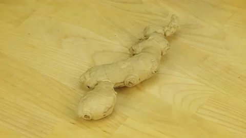 Ginger root rotates on a wooden board Stock Footage 178945264