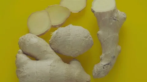Ginger root rotating on a yellow background Stock Footage 72533114