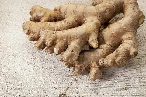 Ginger root on a rustic white painted barn wood background Stock Photos