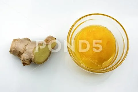 Ginger root with a saucer of honey Stock Photos