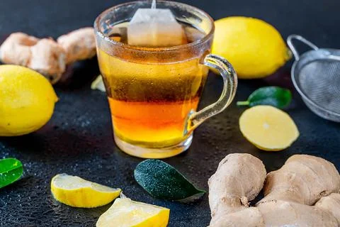 Ginger root tea with lemon on dark background Stock Photos