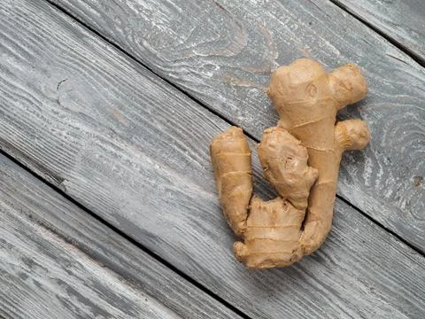 Ginger root on wooden background. Stock Photos