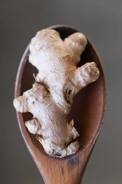 Ginger root on a wooden spoon Stock Photos