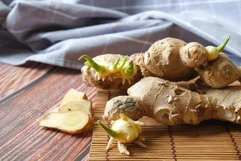 Ginger root with wooden texture background Stock Photos
