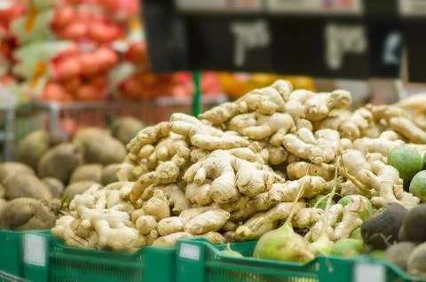 Ginger roots in boxes in supermarket Stock Photos
