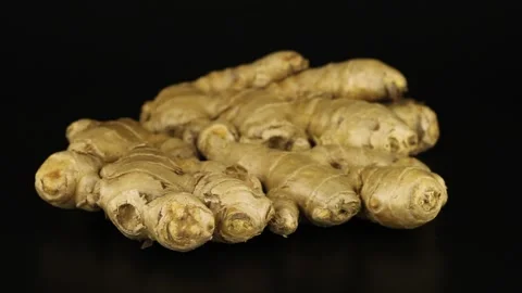 Ginger roots rotate on a black background. Close-up video of spices. 스톡 동영상 152047159
