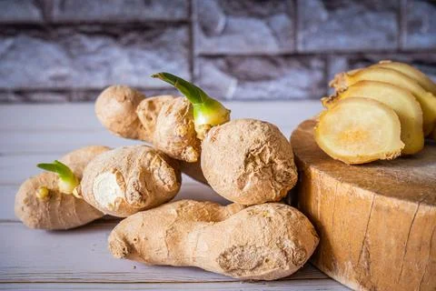 Ginger roots with slices of ginger Stock Photos