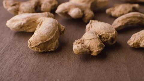 Ginger roots on the wooden table Stock Photos