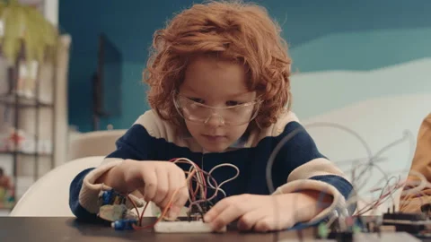 Ginger Schoolboy Constructing Robot Video stock 153463094