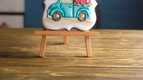 Ginger shaped gingerbread in glaze with pattern of blue retro truck with flowers Stock Footage 112319149