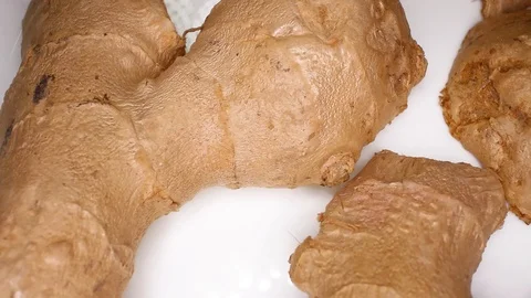 Ginger Spicy Ginger Slices on Rotating Rolling Plate Background Video For Any Video stock 127500096