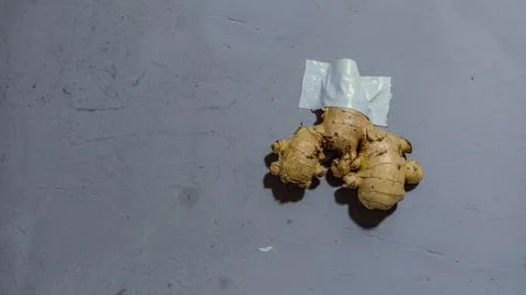 Ginger stuck to the wall using white adhesive. Stock Photos