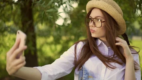 Ginger student smiling and making selfie in park on summer day 動画素材 95247254