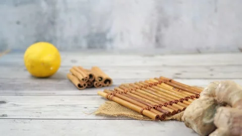 Ginger tea with lemon and cinnamon on a wooden surface Stock Footage 325756926