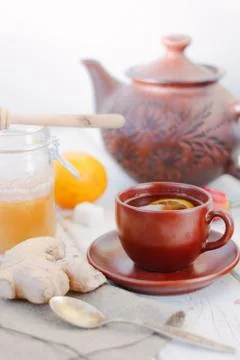 Ginger tea with lemon, lime and honey on white. Stock Photos