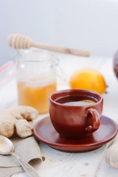 Ginger tea with lemon, lime and honey on white. Stock Photos