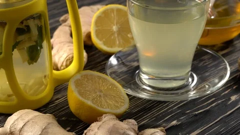 Ginger tea with lemon, mint and honey on wooden background. Stock Footage 75746654